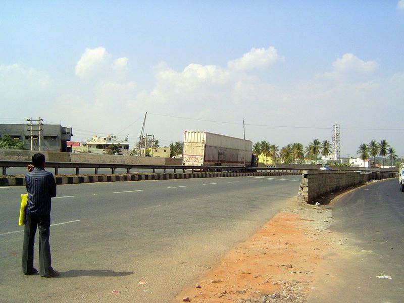 National Highway 4 is part of the "golden quadrilateral." The van is one of many that ferry new Maruti cars south from the assembly plant in