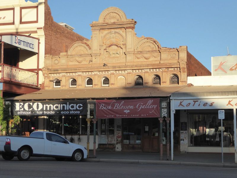 Lots of old store fronts survive. The words above the muscular steer read: Moher and Smith Butchers, Wholesale & Retail.