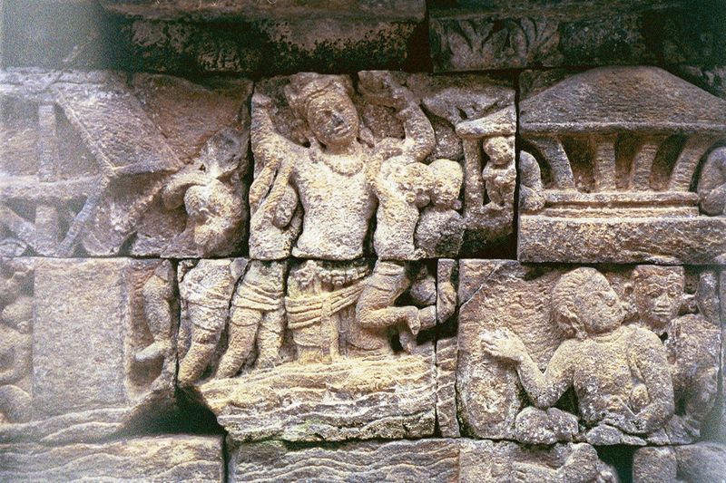 On the fourth level balustrade, Maitreya's generous actions are shown. Here, he carries people across a river.