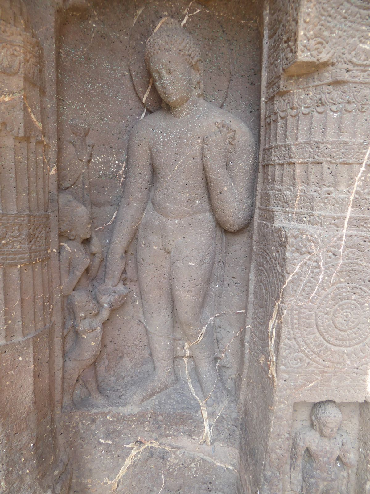 The figure on the lower right is an intrusion; the larger one isn't. It shows the Buddha offering his son Rahula the boy's inheritance. A ki