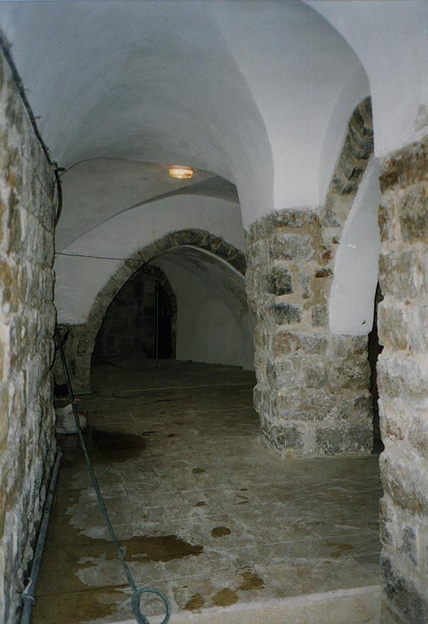 This restored hallway, massive as a Crusader fortress, serves several compound houses.