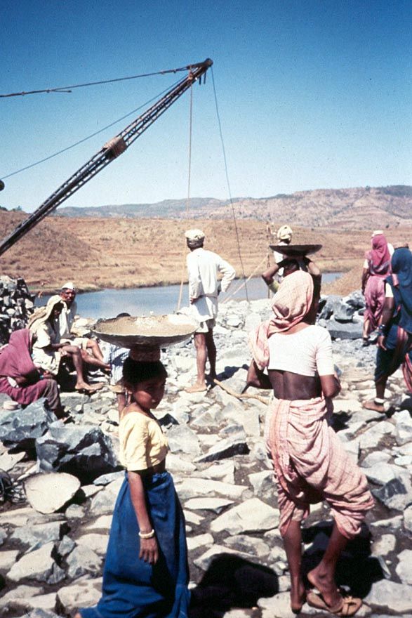 But woe to the politician who tries to stop dam construction. Here, a dam is under construction at Varasgaon, near Pune Poona. Men place and