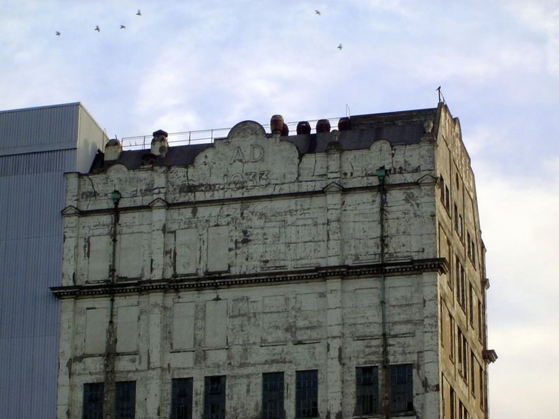 A gabled wing of a secondary building of the Millennium Mills. The date is 1933.