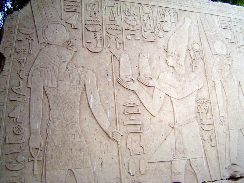 Still another: Alexander the Great offers bread to Montu, the Lord of Thebes, distinguished by the solar disk and twin plumes.