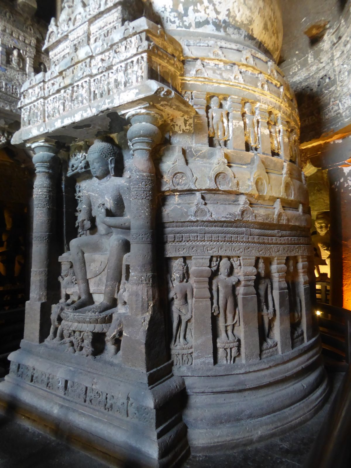 Spink suggests that the sculptors originally intended a standing Buddha, but when he sat down they ran out of space and had to move the atte