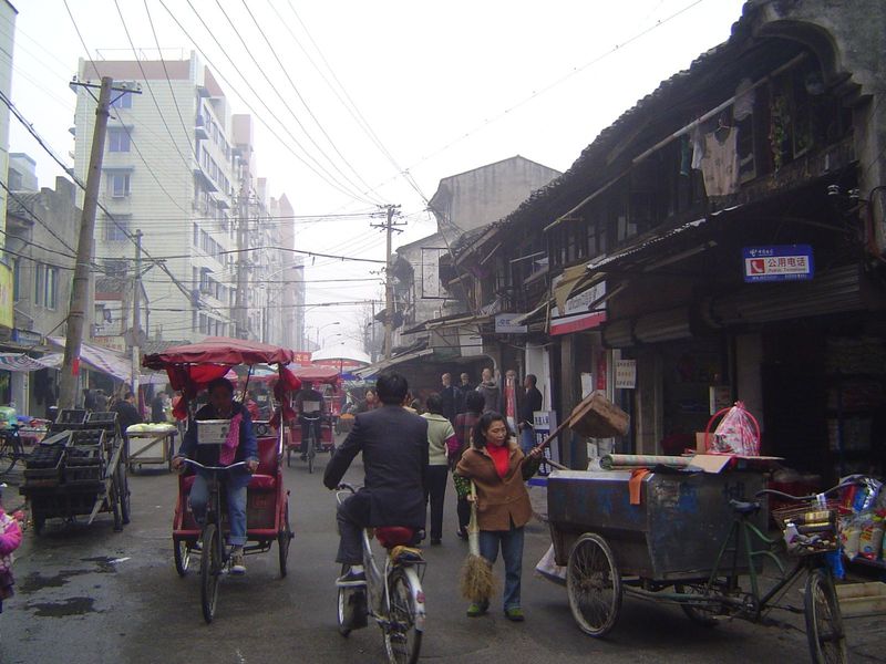 Cycle-rickshaws; charcoal briquets on the left.