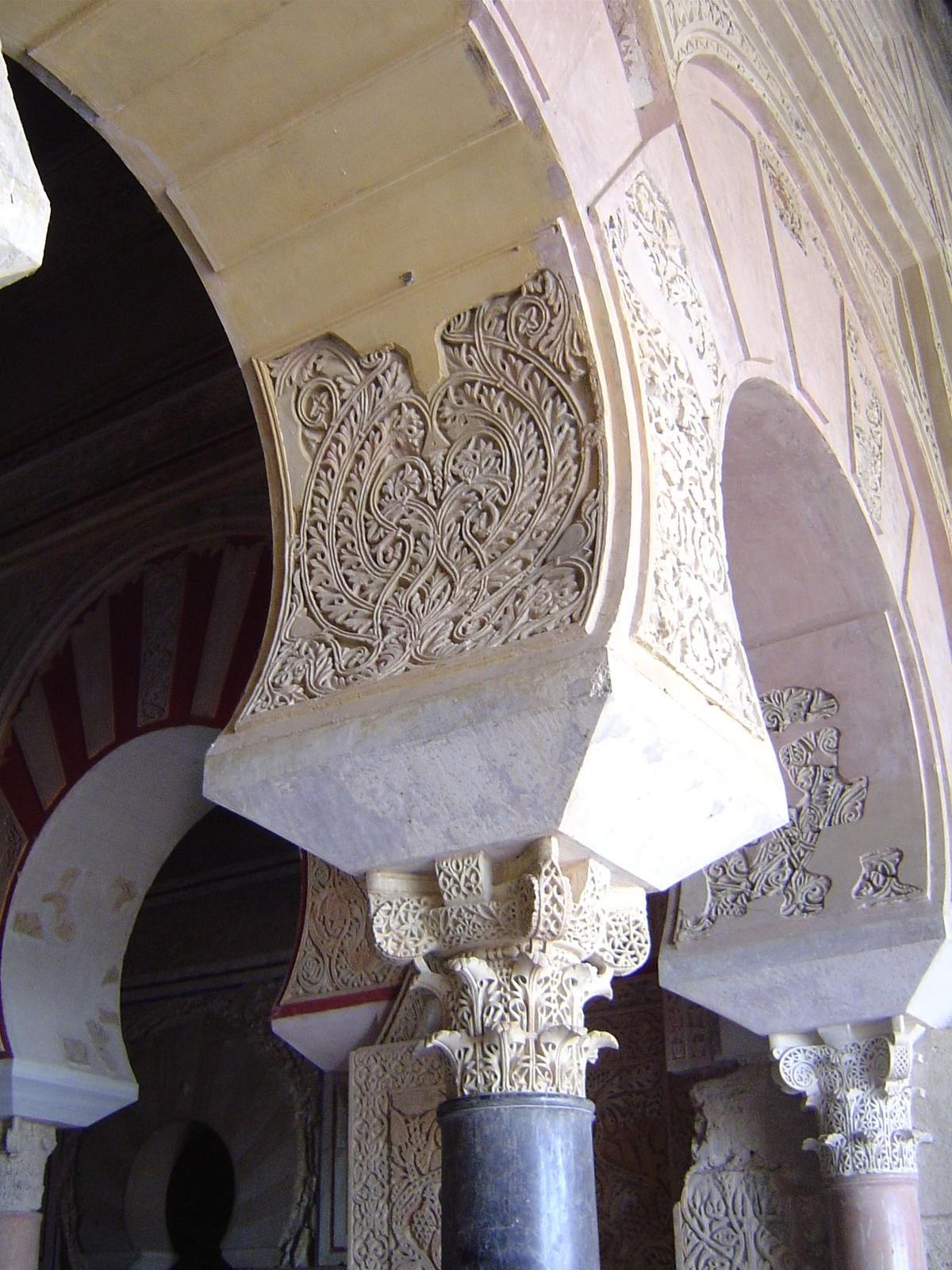 The arches rest on a distinctive capital. The sculpted wall panels above are called atauriques .