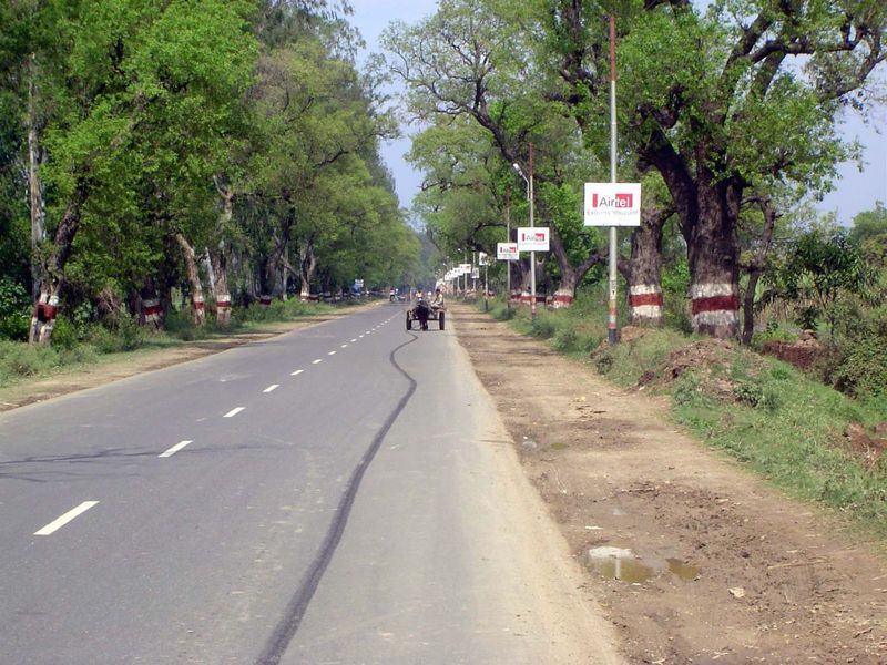 Upgrade: the national highway from Delhi to Haridwar as it was in 2006; the endlessly repetitive signs advertise cell phones with the motto,