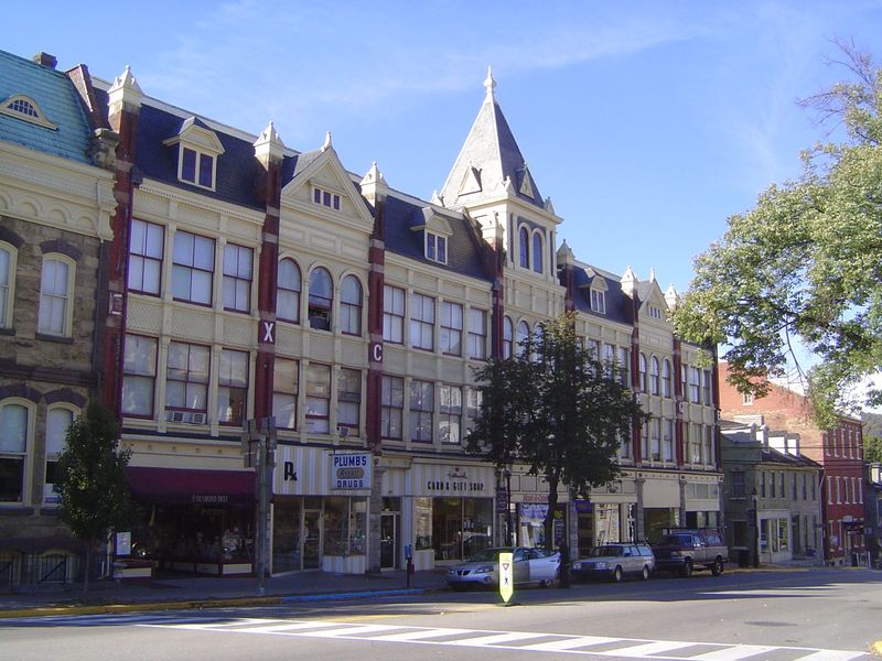 A block to the north, the Crider Exchange was built in 1889 with an iron frame, lots of windows, and fish-scale, pressed-metal sheets betwee