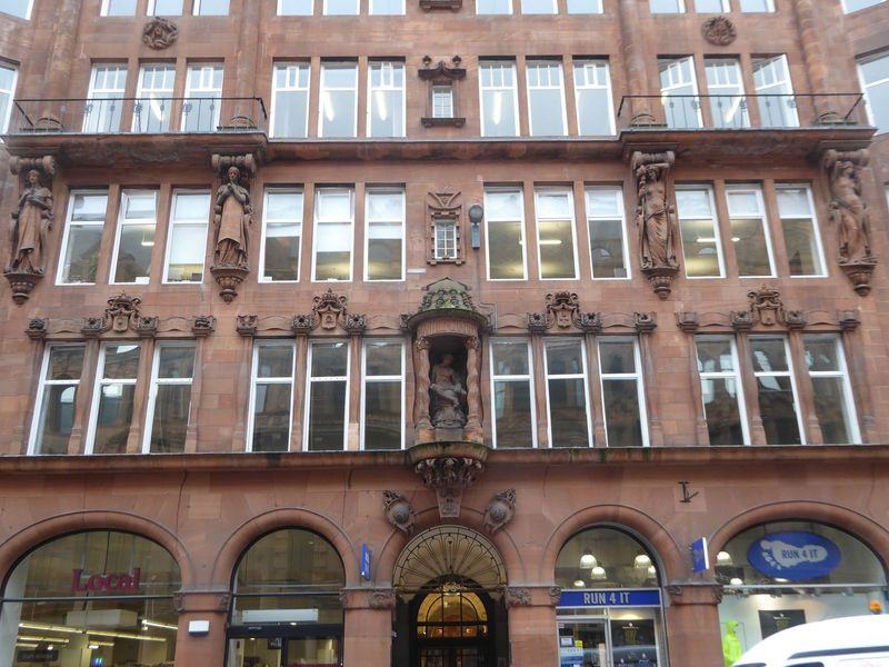 Just across the street is this, the Mercantile Chambers, from 1897. The facade is severe but alleviated by damsels representing Industry, Pr