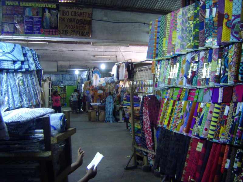 Upstairs, there's a collection of cloth stalls. It's hot as an oven in here.