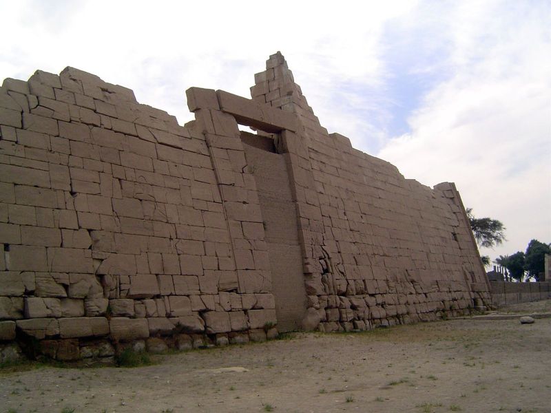 The first pylon—its entrance blocked—is made of sandstone instead of the usual mud brick. Internal staircases at either end lead to the top.