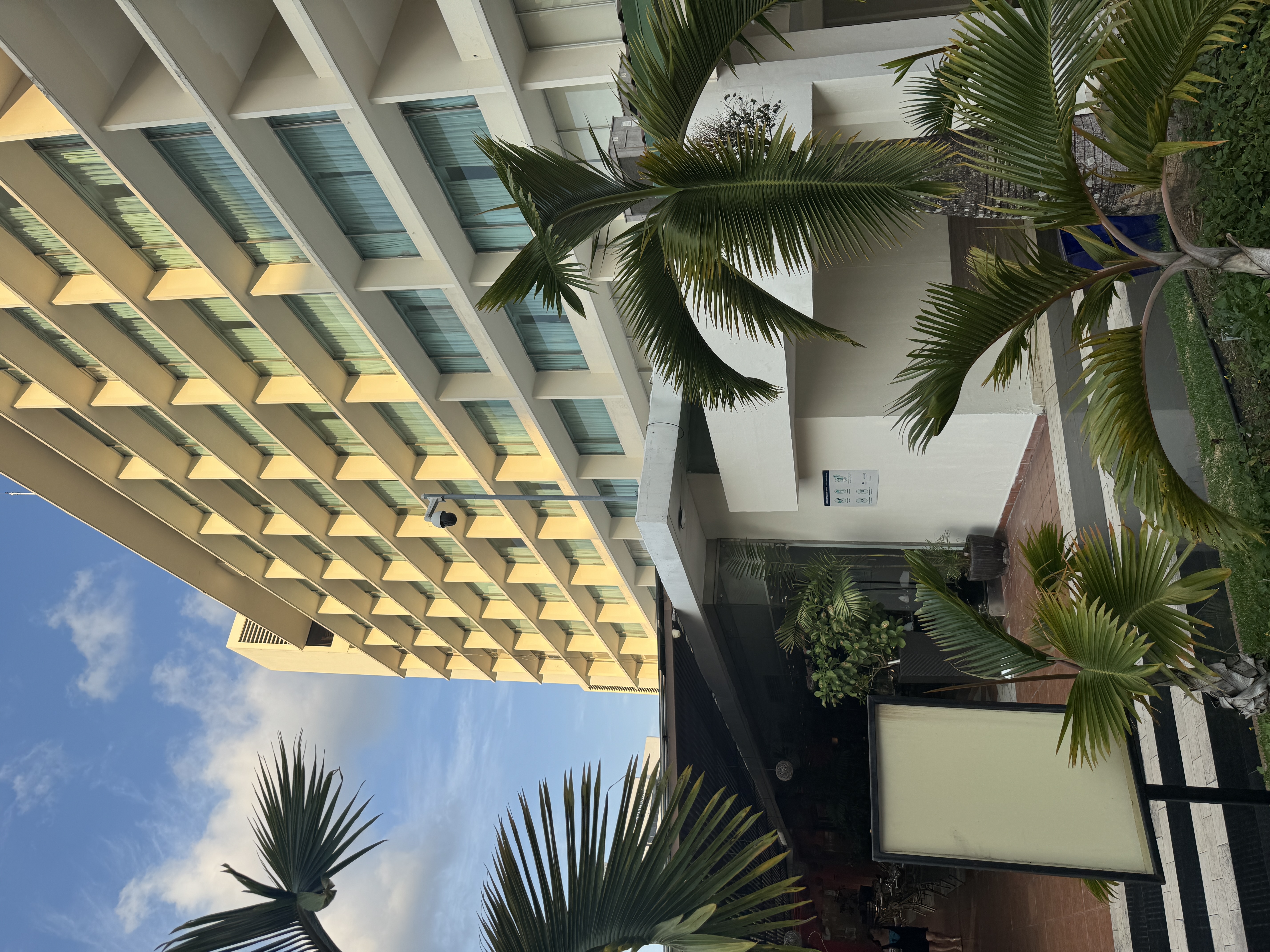 The hotel still stands, but the Hilton name came down in 2017, and the balconies and louvers are gone.