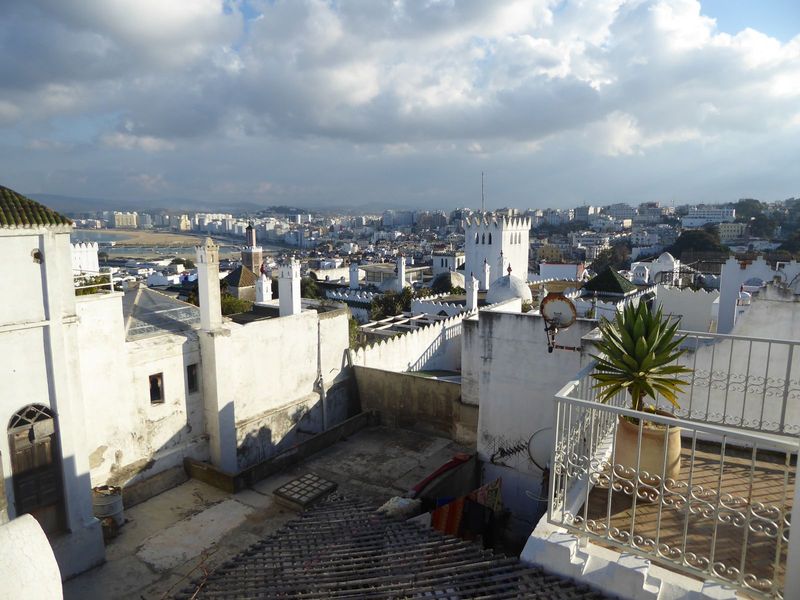 View in the other direction, over the medina sloping downhill from here, with the modern city beyond. See the yellow building on the right a