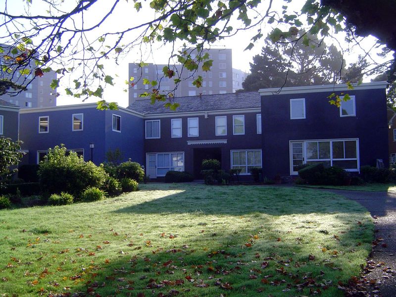 The view from the courtyard back toward the archway. The living room had the large windows; upstairs you see the window of the boy's room an