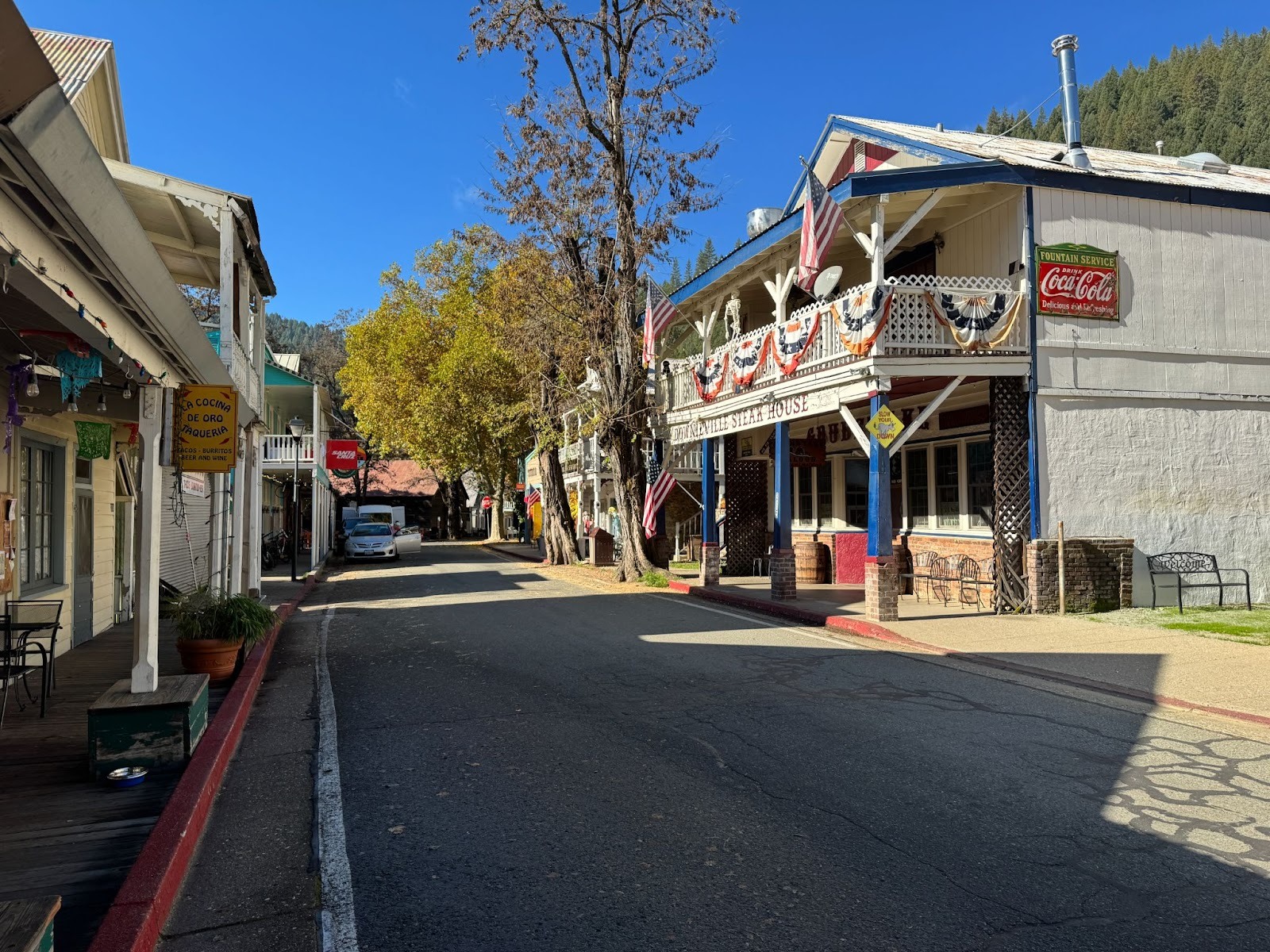 We're looking the other way on the same street; the yellow building is on the right side at the far end.