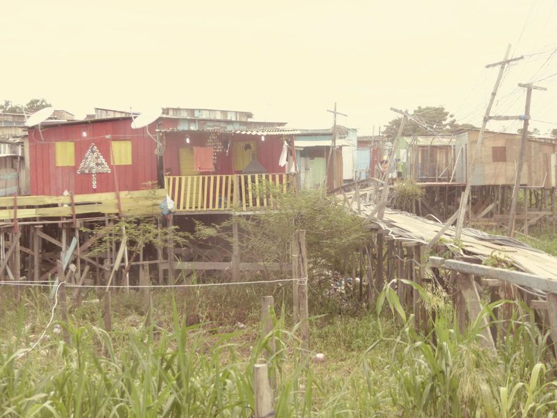The satellite dishes are but probably shouldn't be a surprise. These houses, approached over the flimsiest plank paths, do have water and po