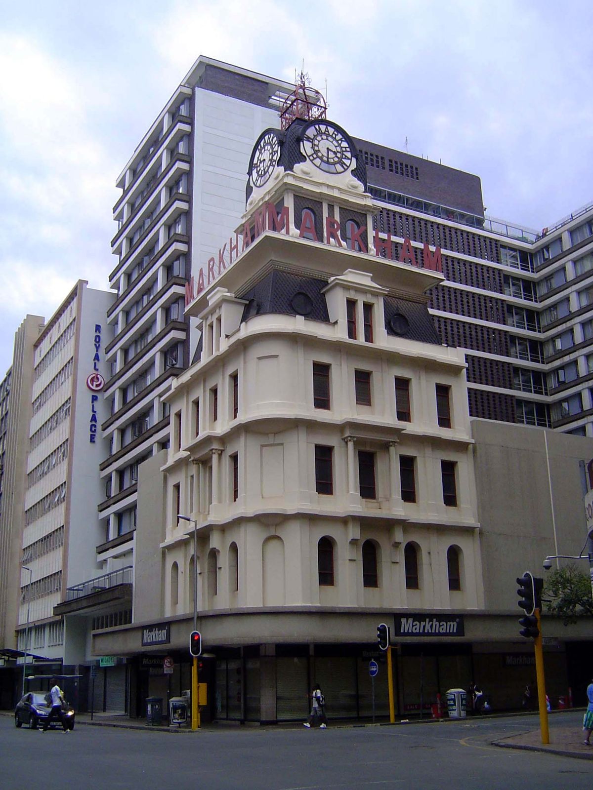 The rooftop sign is original, but the ground-level ones replace a wraparound that read: "H.W. Markham, Outfitter & Clothier; Gentlemen's Com