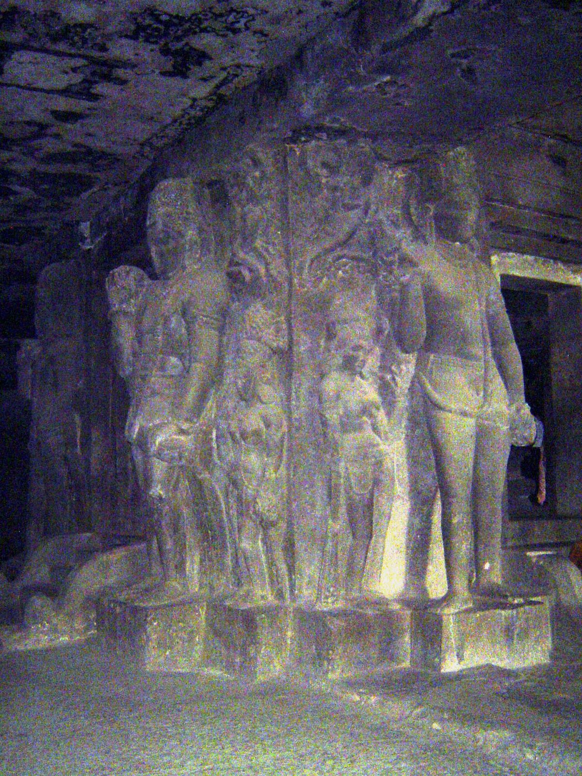 The shrine is square, its corners carved with pairs of guards, dvarapalas, protecting the lingam.