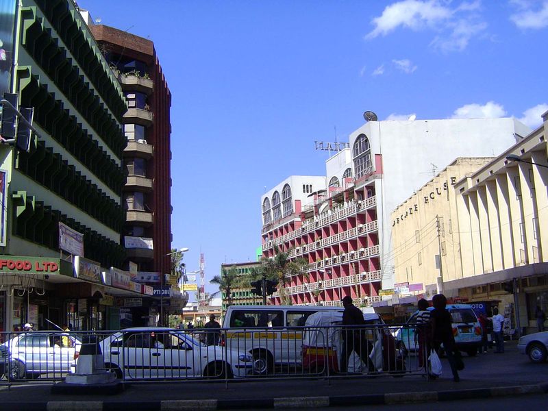 Behind the people, the buildings are mostly post-colonial and formulaically modern.