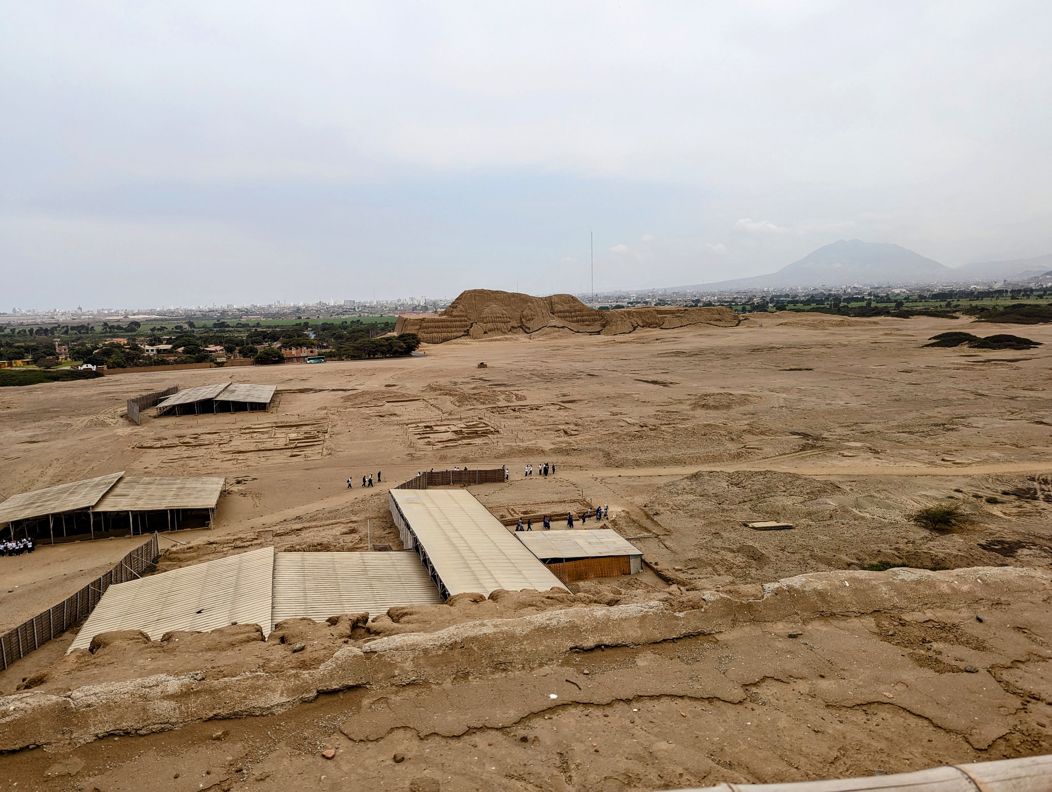 The same Huaca de la Luna, with the urban flats and, in the distance, the largely demolished Huaca del Sol.