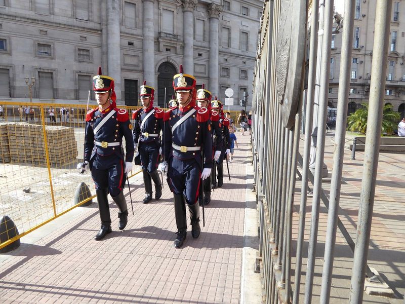A changing of the guard. Funny how the lack of guns makes them seem like they're in costume for an operetta.

The building behind them house