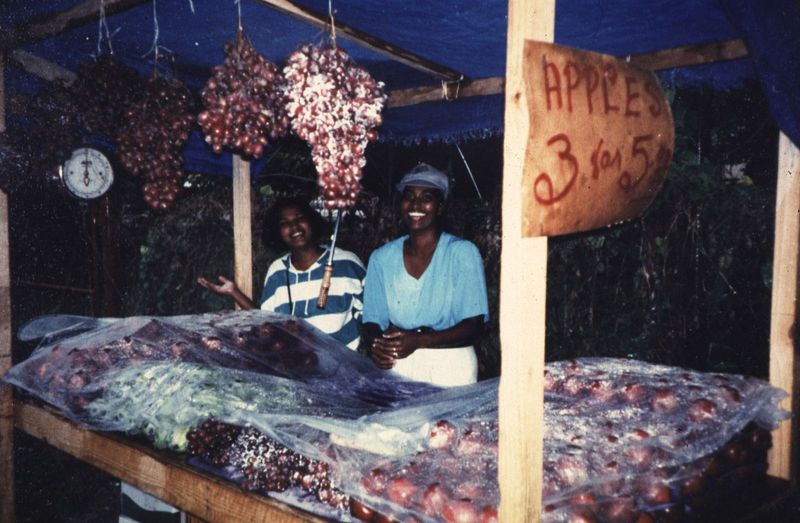 Chaguanas is not wholly Indian. Here, two girls sell Washington State apples as well, it seems, as star apples.