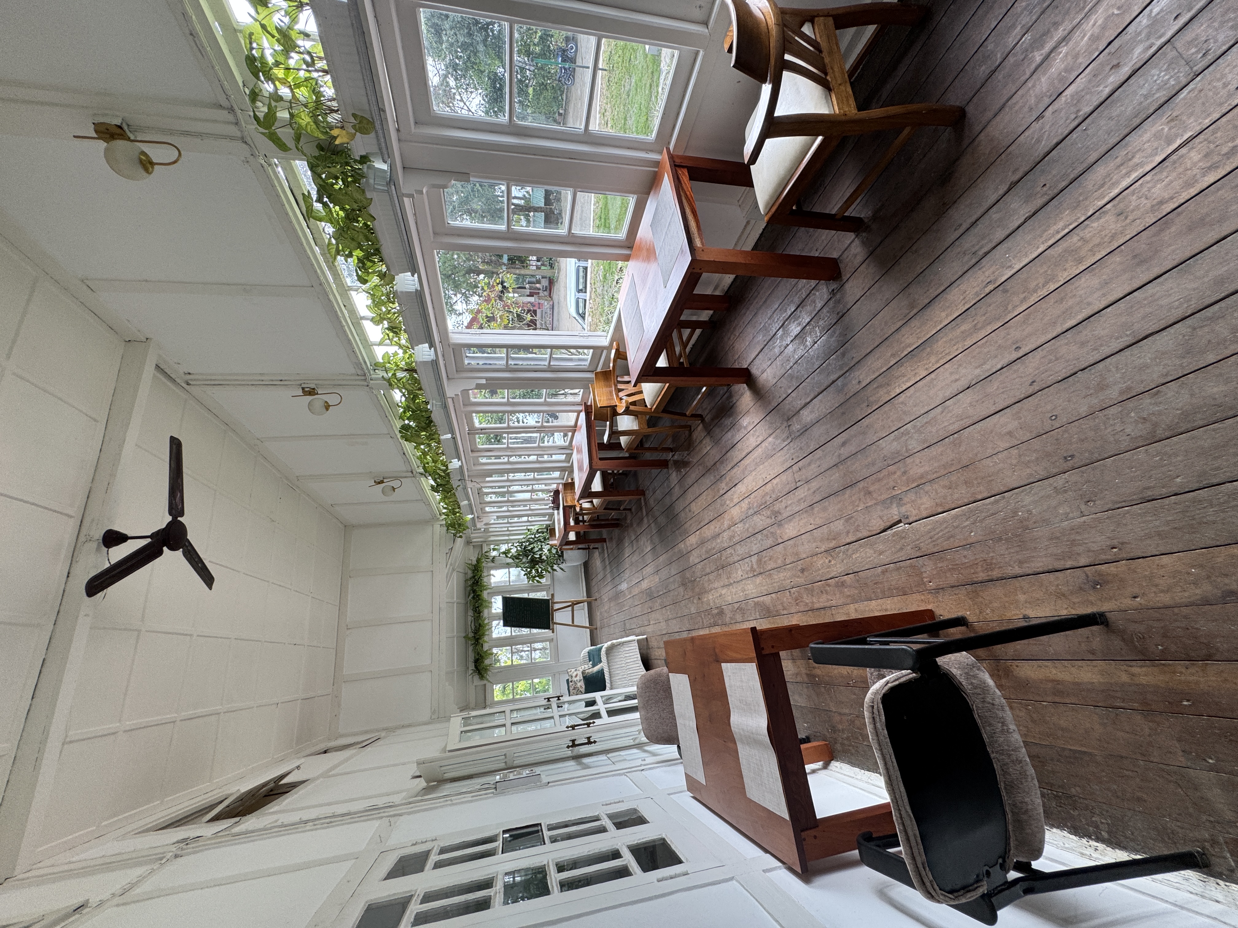 The building is the Heritage Hotel.  Nobody on site knew its age, but here is the dining porch.