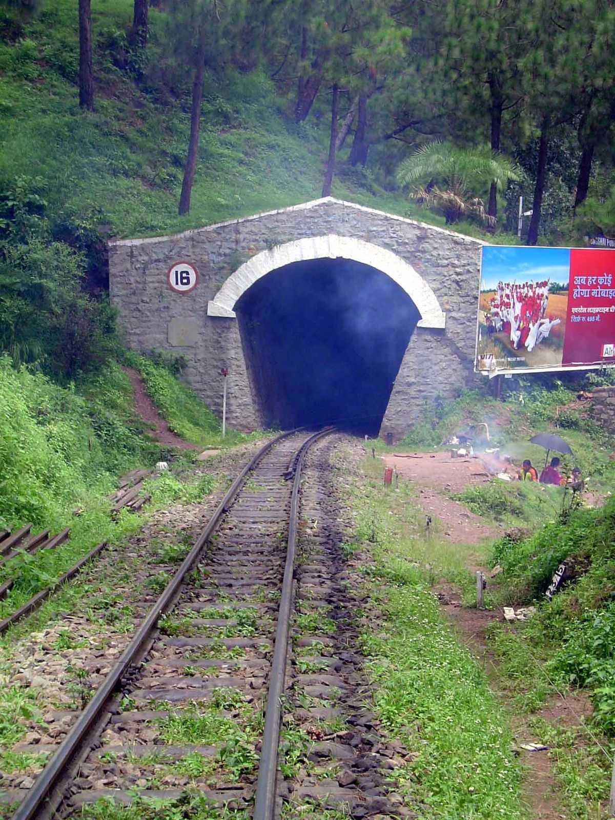 There are many tunnels along the narrow-gauge route. The smoke here isn't coming from an engine, though; it's from the women by the umbrella