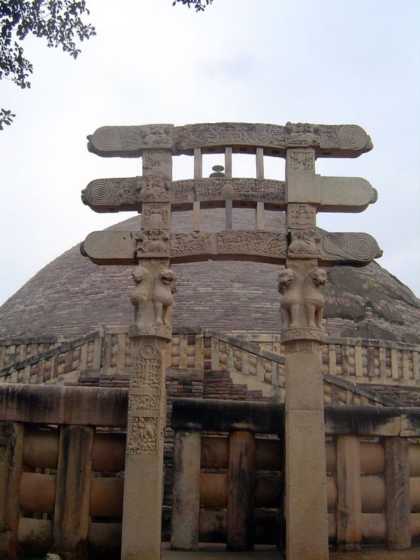The south gateway. Note the double staircase by which the terrace or medhi is reached. The capitals beneath the architraves show the famous 