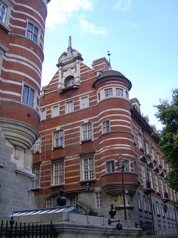 Speaking of courtrooms, here is Norman Shaw's famous New Scotland Yard, with its convict-quarried granite base, its orange-red brick and str