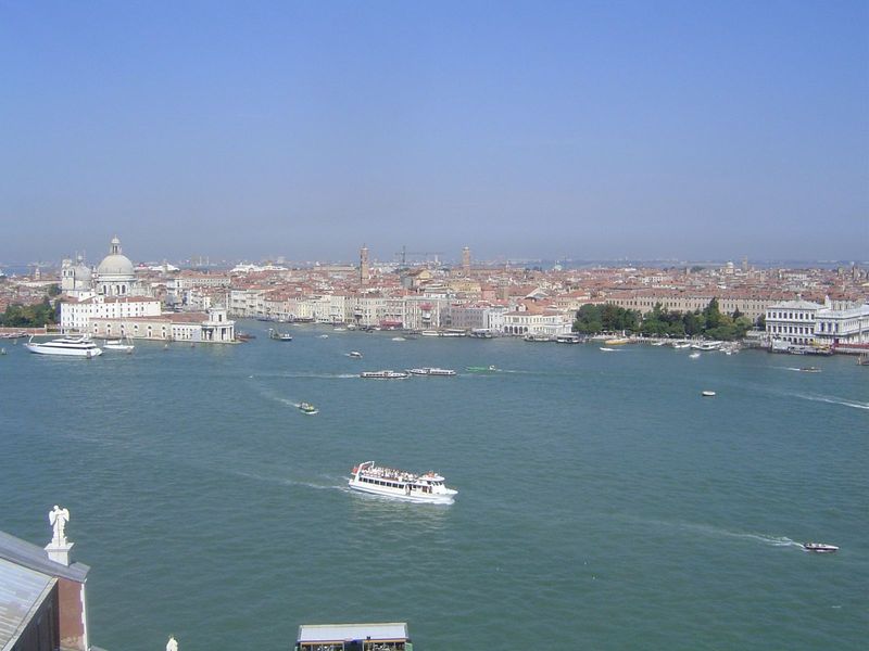 Santa Maria is on the left now. The building in front of it, at the point of land, is the Da Mar Customs House, 1677; on its roof is a golde