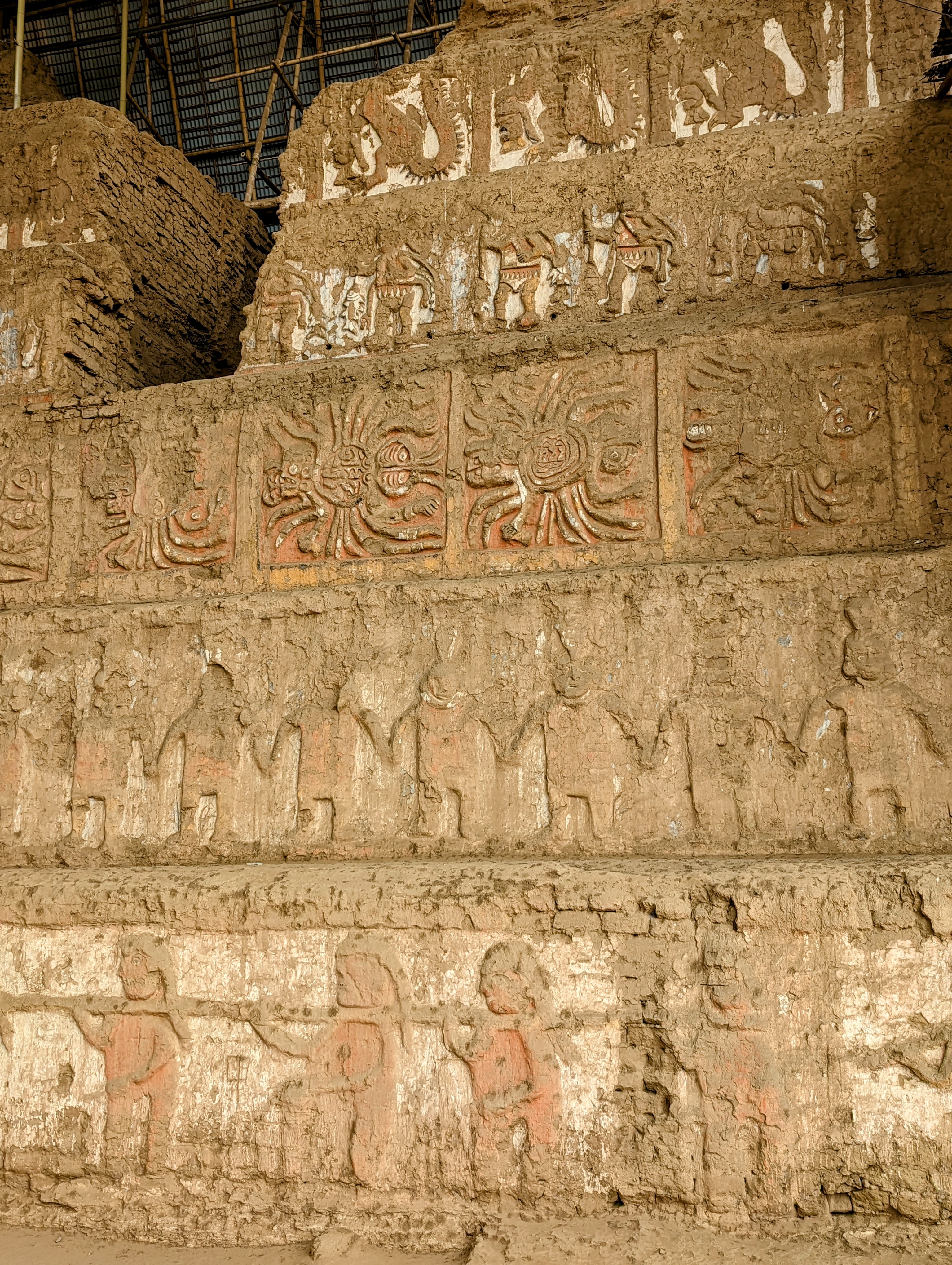The figures in the lower row, tied together at the neck, are prisoners about to be sacrificed.