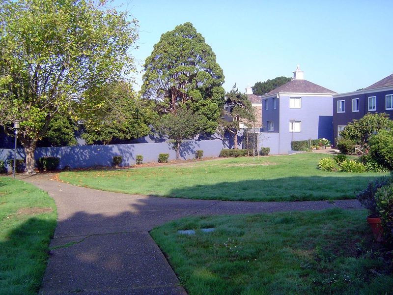 This is the inner courtyard behind the boy's place. Behind the wall—white originally, now black raspberry—was a playground with swings.