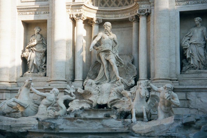 Neptune, flanked by Health and Abundance, rides a chariot led by two tritons the one on the right blows a conch.