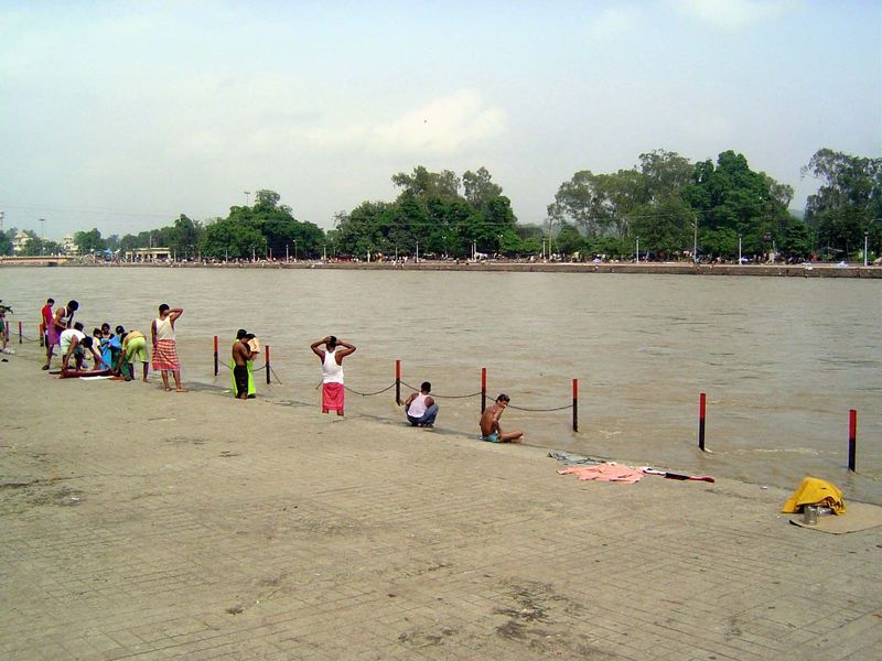 A few miles away, bathers have come to the sacred water.