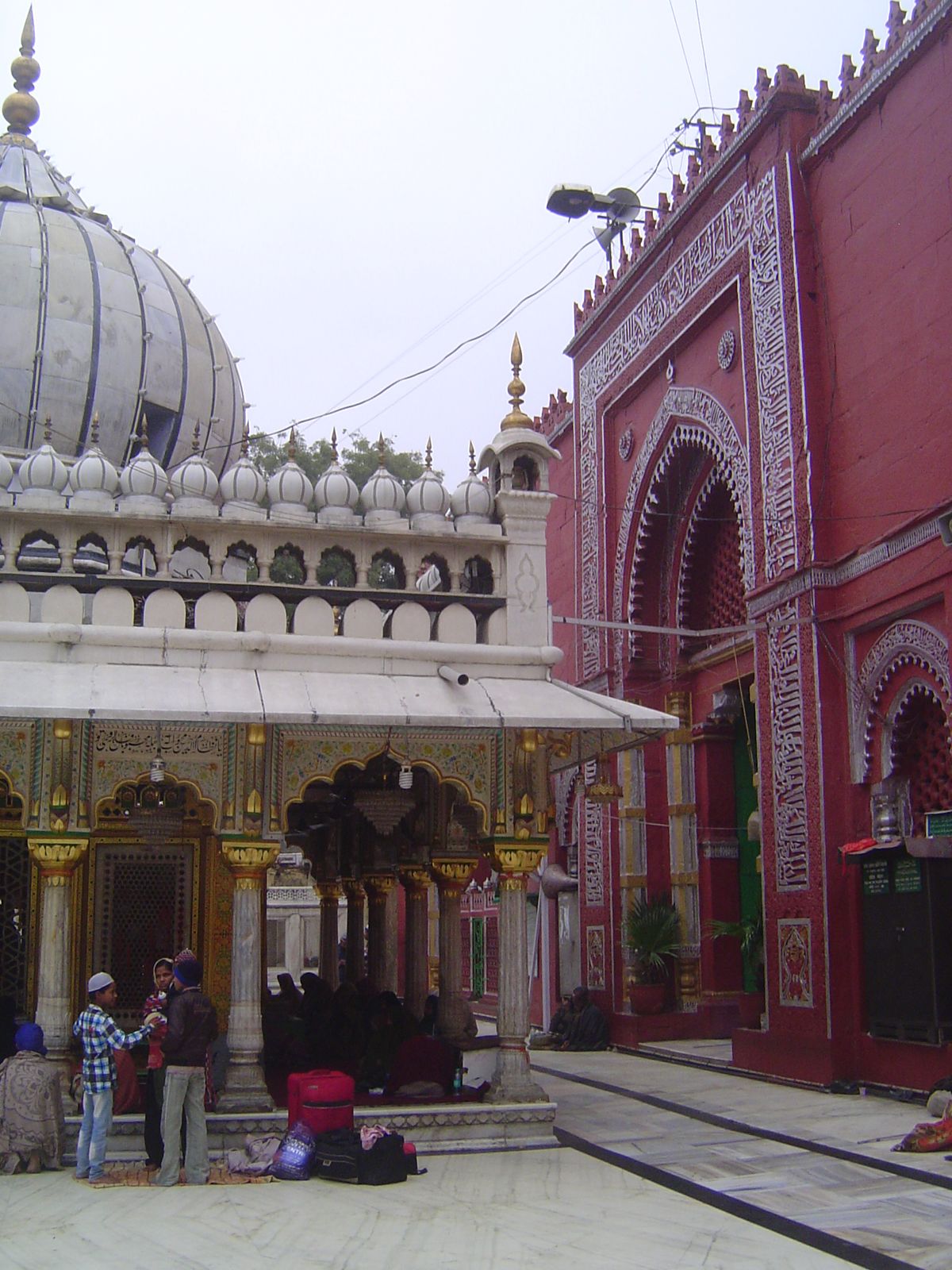 Next to the dargah or shrine is the Jama'at Khana or congregational place, built by Firoz Shah Tughlaq about 1353. Despite the red paint cov