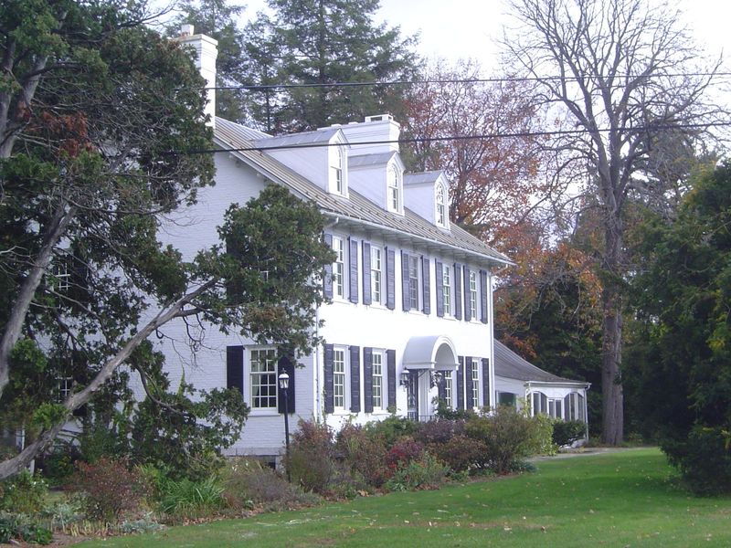The scales vary, but not the gabled roof with dormers, the orientation to the street, and the symmetrical facade.
