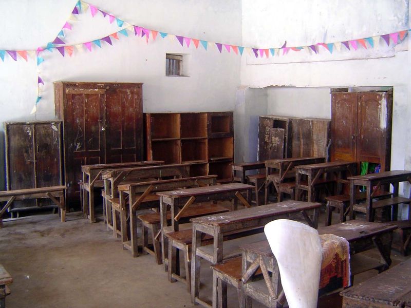 A room to the side reveals all: a school.