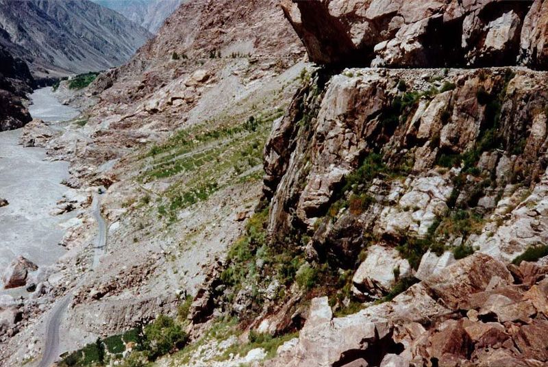 The creek soon joins the Indus River, while the artificial channel hugs the bordering cliff. Bits of irrigated land draw water from the chan