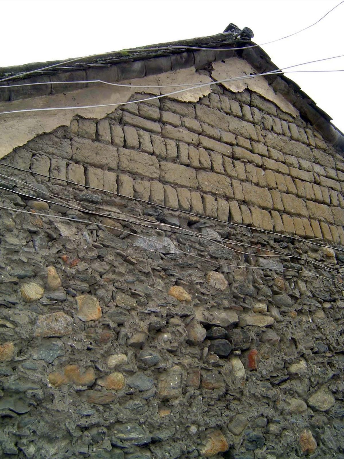 Characteristically, walls are of adobe brick laid on a stone base.