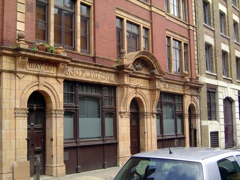 A few blocks to the east, a flash from the past. We're on Whitechapel Road at the Soup Kitchen for the Jewish Poor, dated 1902. Russell and 