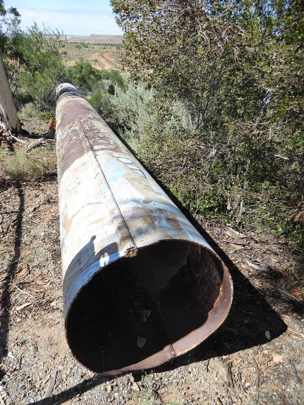 Here's a bit of the original pipe, replaced but saved. It doesn't look like modern pipe; instead, it's two flat sheets were bent into half-c