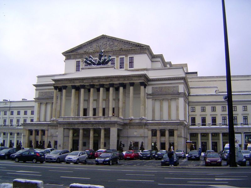 With columns looking like bars on a prison cell, this is the Grand Theater from 1833. Most of the building is post-war reconstruction, but t