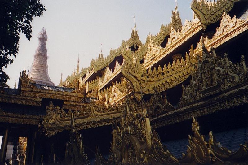 The approach to the pagoda is along covered avenues lined with shops and roofed as garishly as means allow.