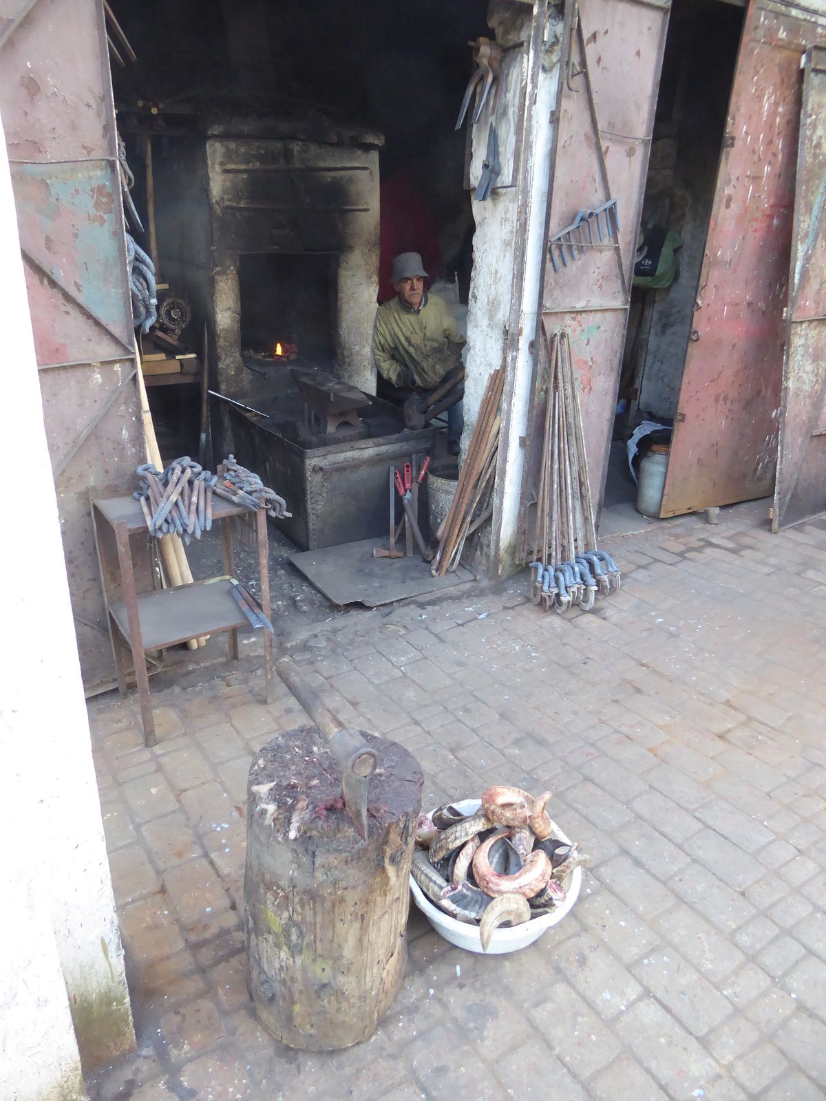 Let's walk around the old perimeter of the old city, beginning with a blacksmith who has a plastic pail of sheep horns. Go figure.