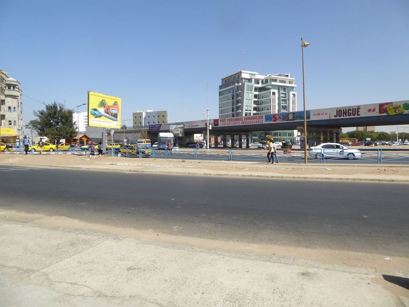 Keep walking inland and you approach the contemporary city, spread-out enough to require highways and overpasses. The advertisements include