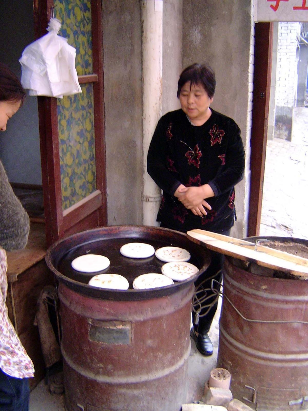 Along the street, bread is cooked over a barrel oven.

Recommended reading on Xi'an: Zou Zongxu, The Land Within the Passes: A History of Xi