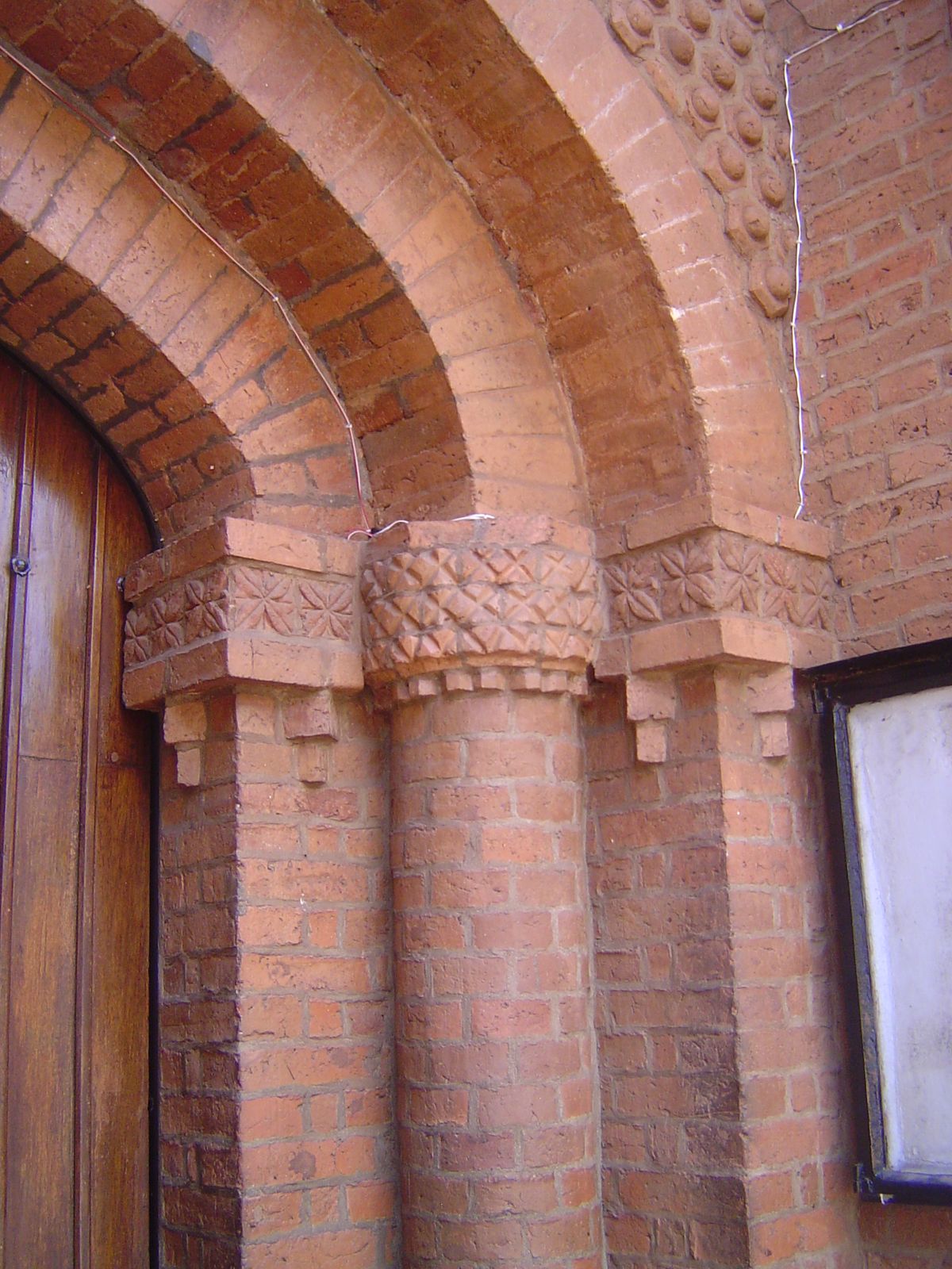 Abstract figures, compound arches, and oversized bricks.