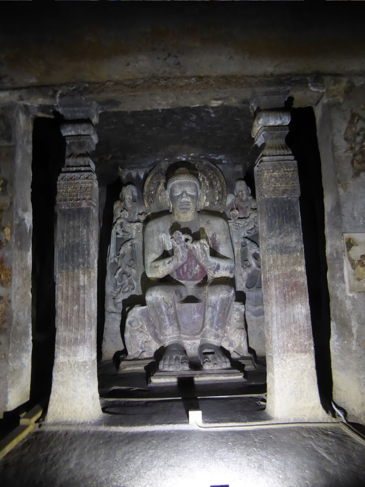 The shrine carries an image of the Buddha in the instructive dharmachakra or teaching mudra. There's also room behind him for monks to circl